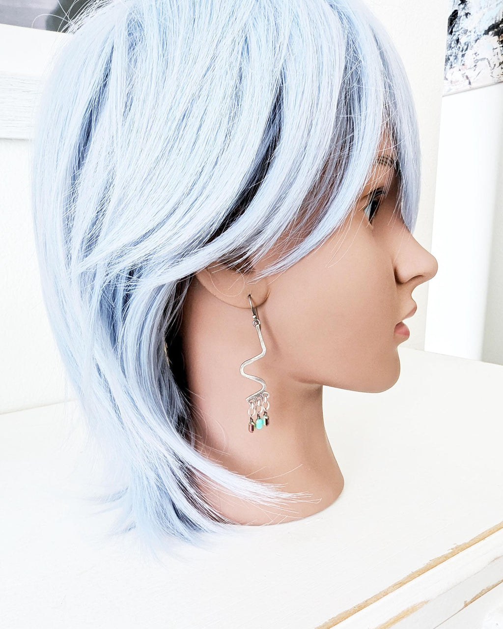 Boho statement earrings featuring AB crystal bead movement on mannequin for scale