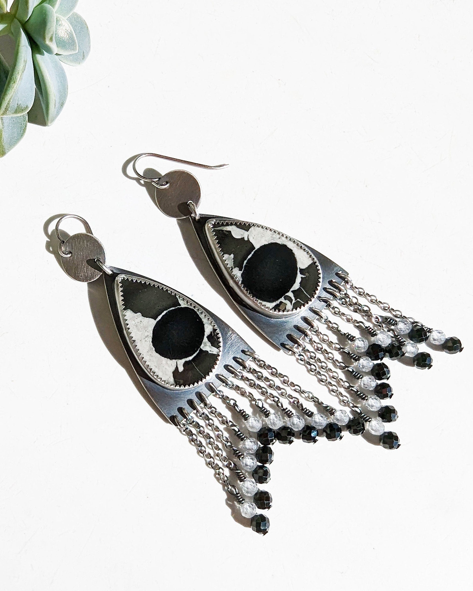 Close-up of pear-shaped septarian fossil earrings showing natural patterns
