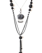 Snowflake obsidian pendant worn on chain layered with a bead necklace to show chandelier style width and length
