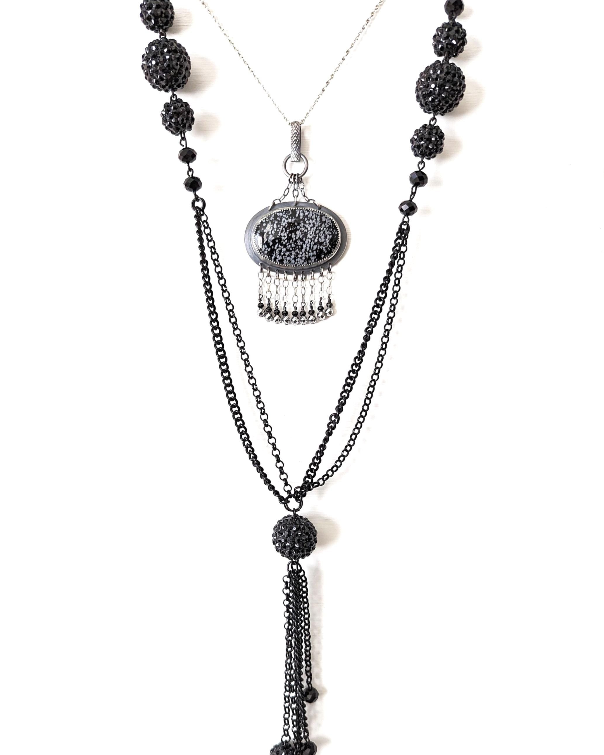 Snowflake obsidian pendant worn on chain layered with a bead necklace to show chandelier style width and length
