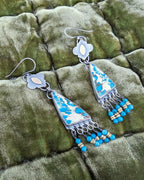 Asymmetrical artisan earrings with ocean-inspired color palette