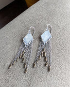 Close up of pyrite fringe earrings with diamond-shaped oxidized sterling silver drops
