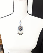 Statement boho pendant featuring black, brown, and white banded agate shown on bust for size