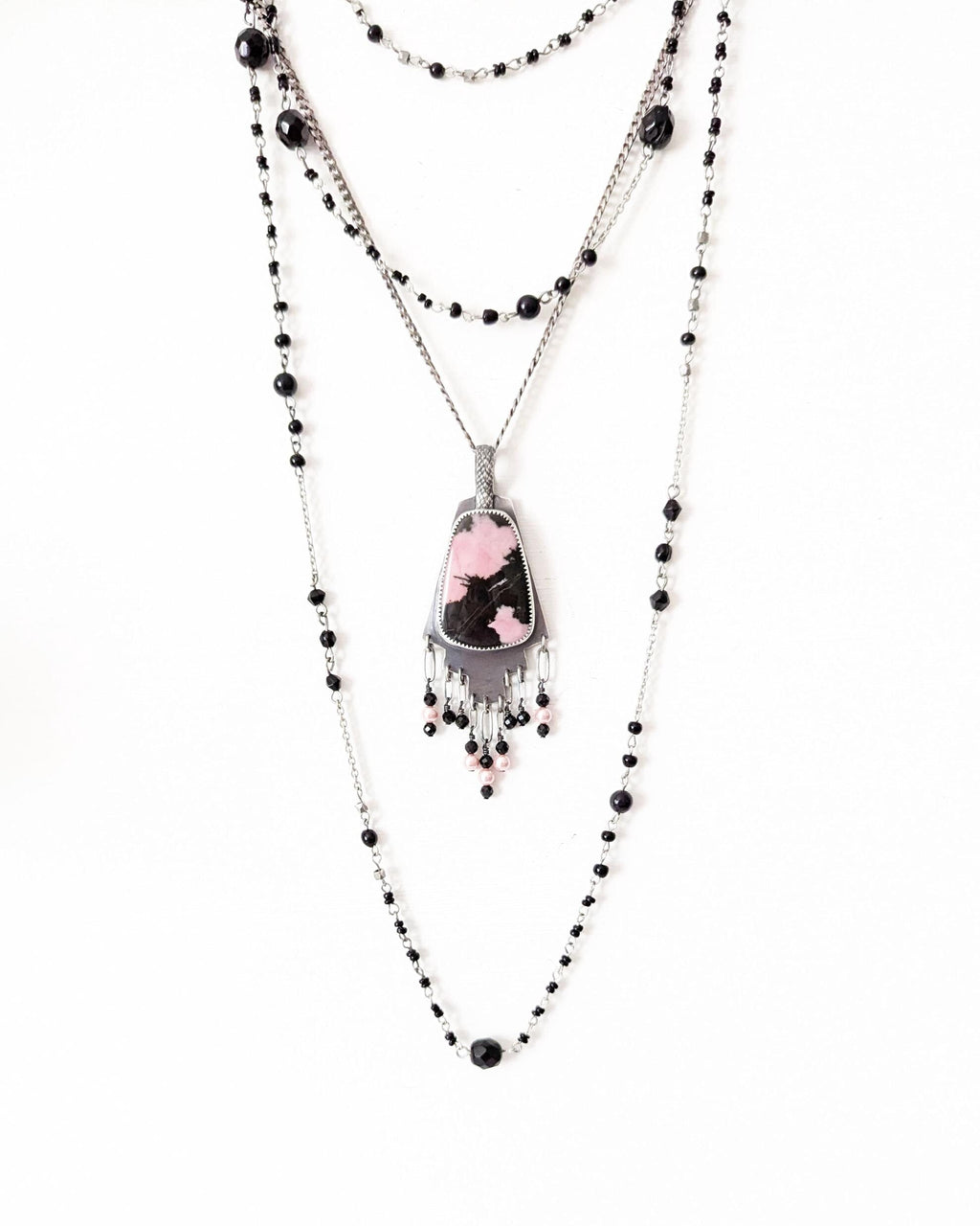 Black tourmaline and glass pearl fringe beneath rhodonite gemstone shown on chain with layering necklace (not included)
