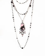 Black tourmaline and glass pearl fringe beneath rhodonite gemstone shown on chain with layering necklace (not included)
