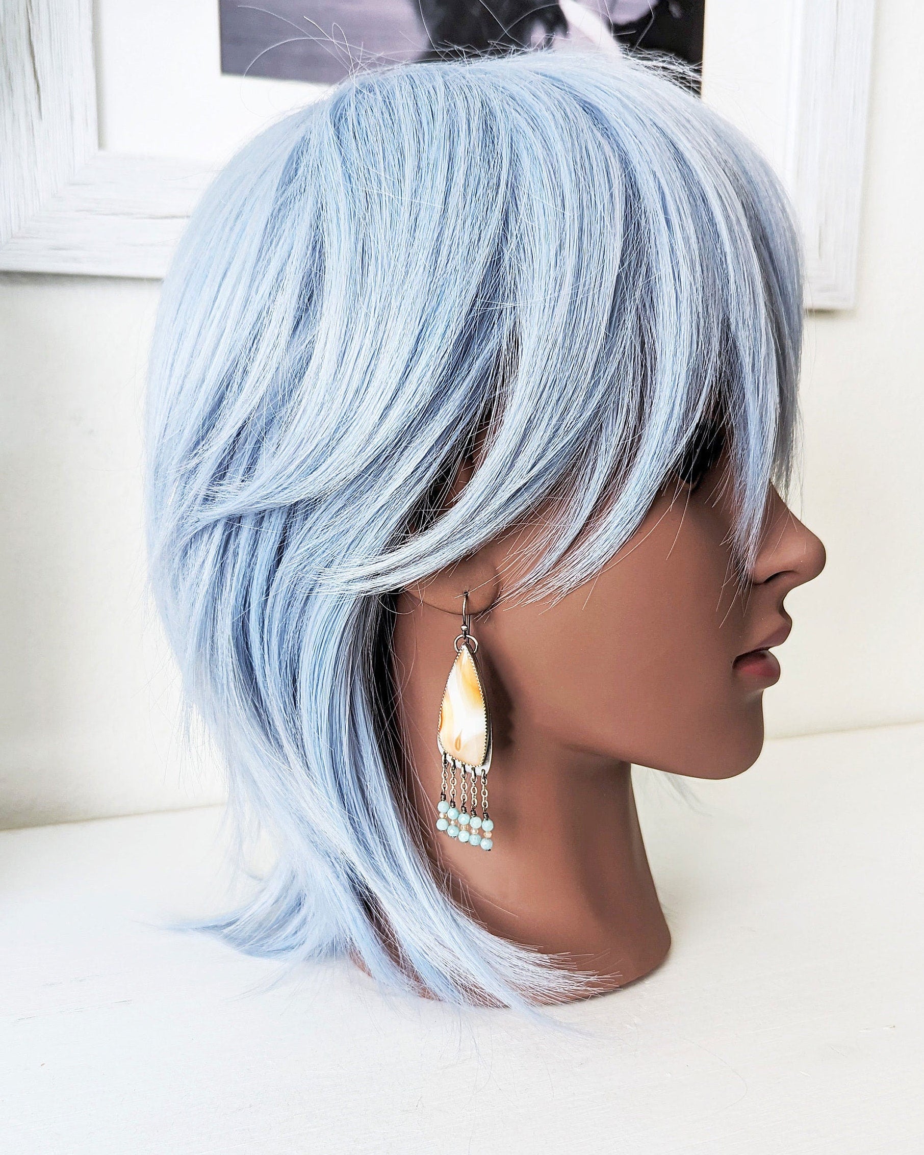 Artisan handmade agate earrings with larimar and sunstone beads on mannequin for scale
