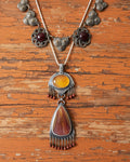 Warm-toned artisan statement pendant in gold and brown hues
