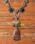 Warm-toned artisan statement pendant in gold and brown hues