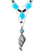 Mixed-material statement pendant featuring Fordite and pyrite on chain with layer necklace (not included)