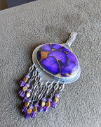 Amethyst and brass bead fringe beneath purple turquoise centerpiece