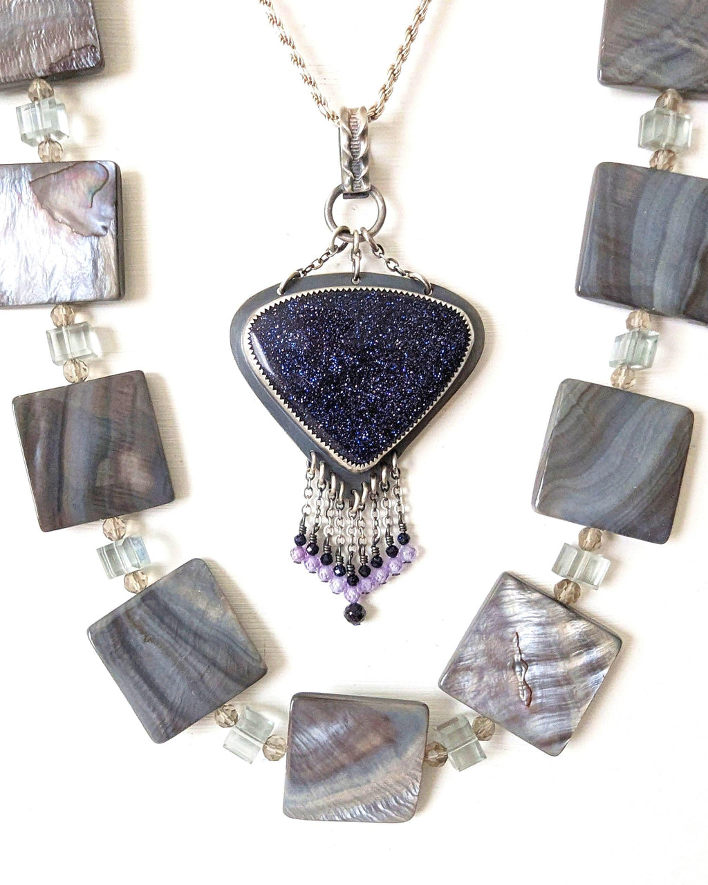 Triangular blue goldstone with copper sparkle in oxidized sterling silver shown with layer necklace and on chain (not included)
