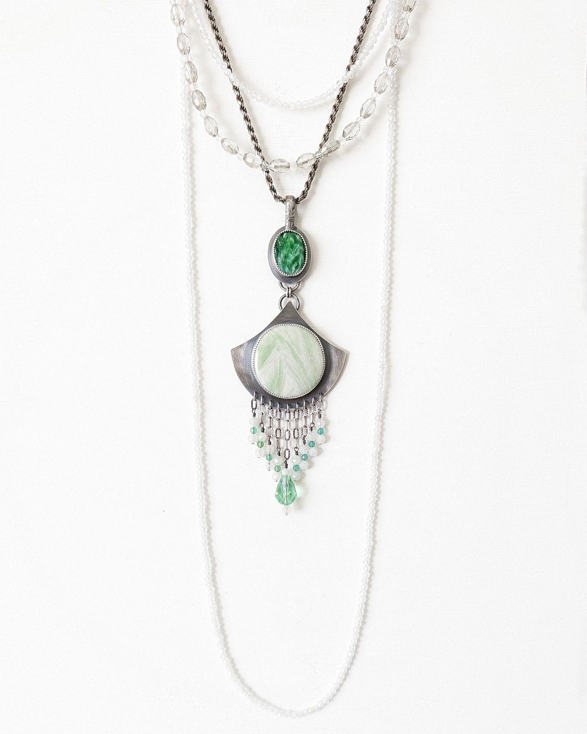 Necklace with green pendant on a white background