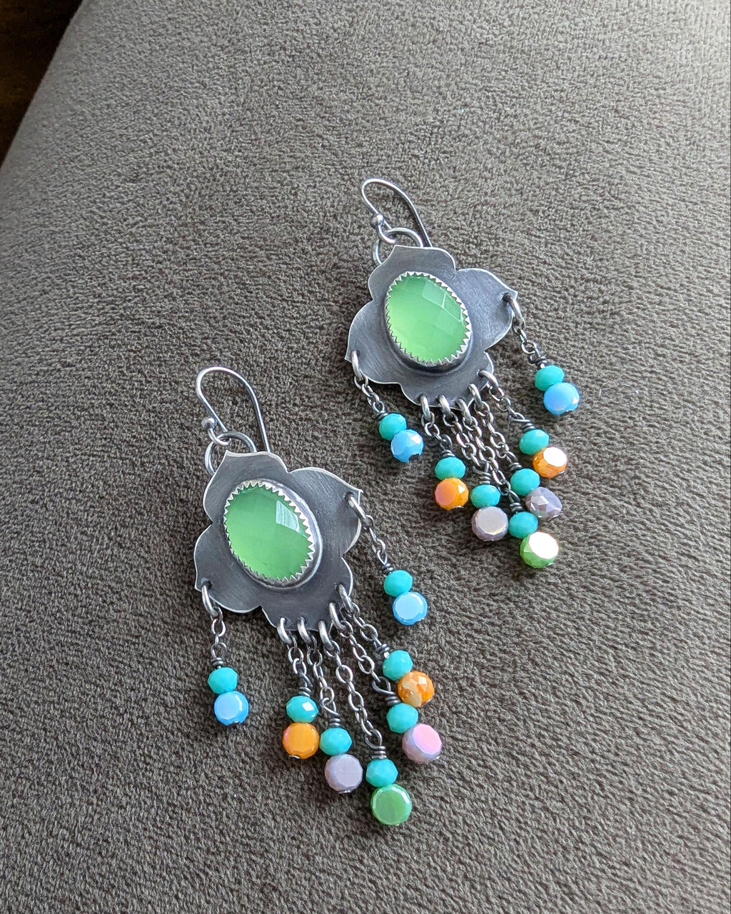 Multicolor crystal bead fringe beneath bright chalcedony stone