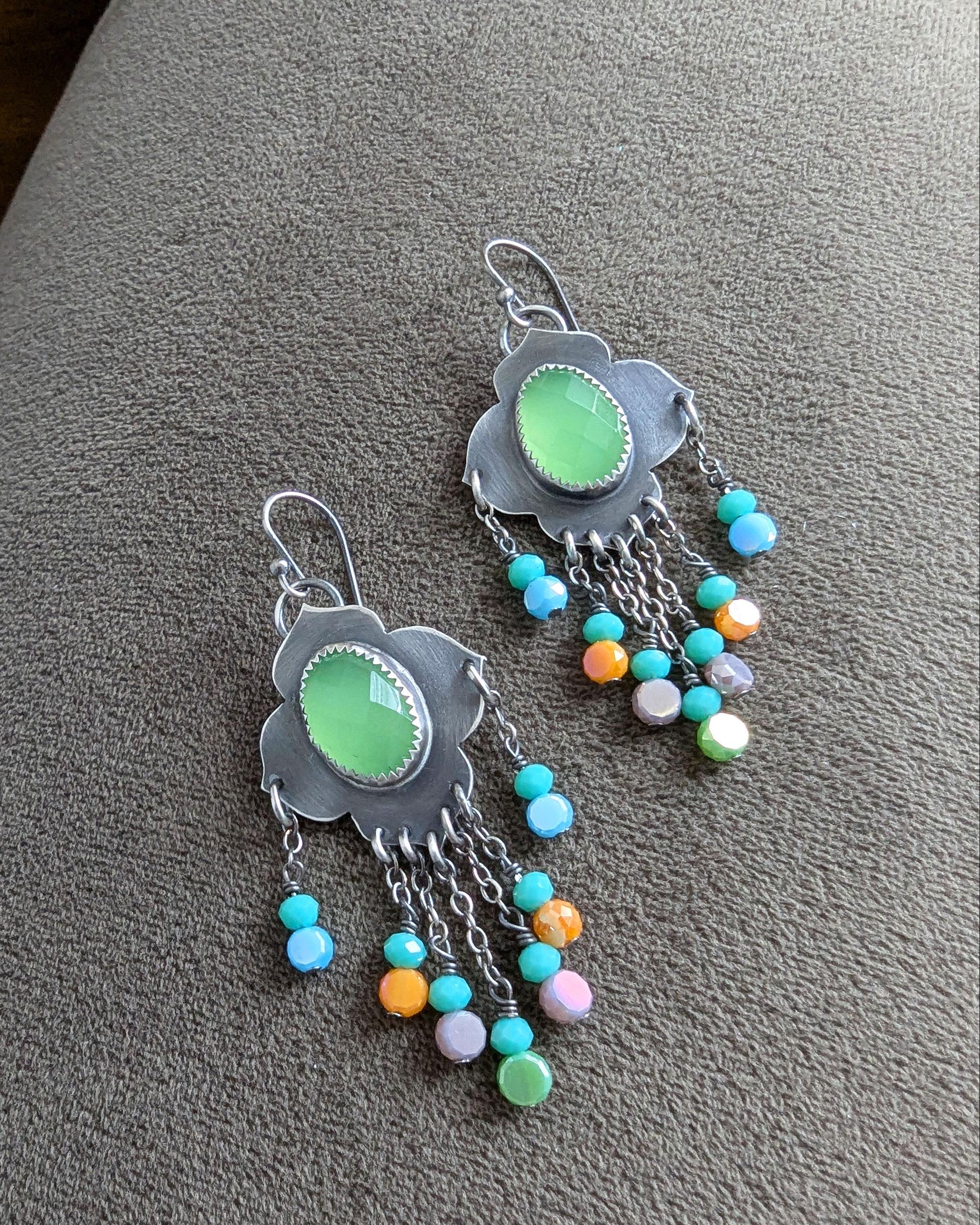 Multicolor crystal bead fringe beneath bright chalcedony stone