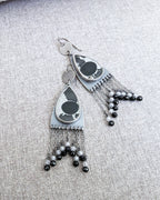 Close-up of pear-shaped septarian fossil earrings showing natural patterns
on fabric