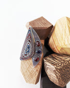 Abstract sailboat Fordite ring with red garnet and blue sapphire accents