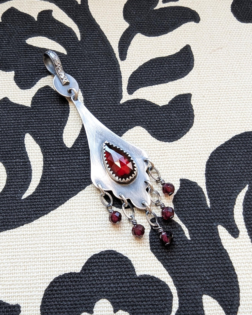 Art Nouveau inspired sterling silver necklace with garnet center