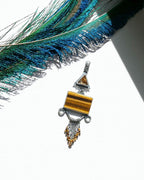 Star rutile quartz and tiger’s eye pendant in oxidized sterling silver filigree