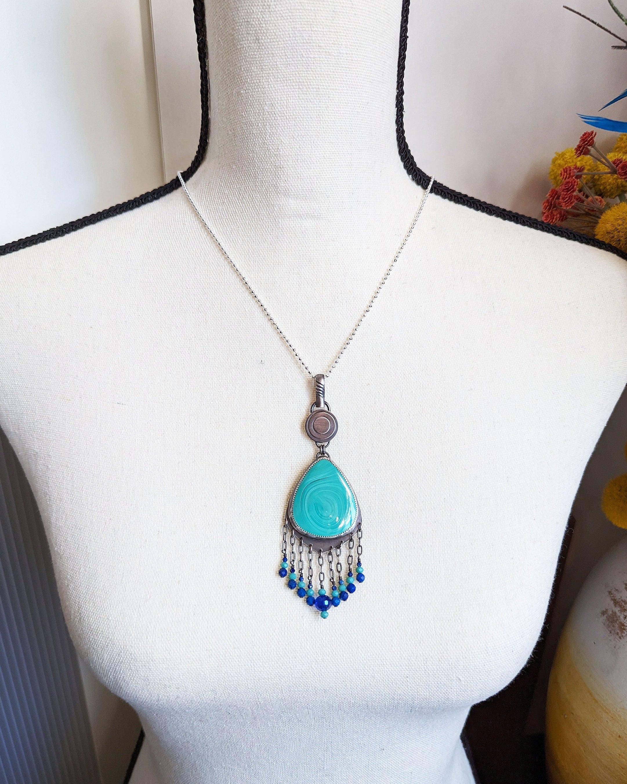 malachite pendant with cobalt crystal bead accent on chain shown on bust for size
