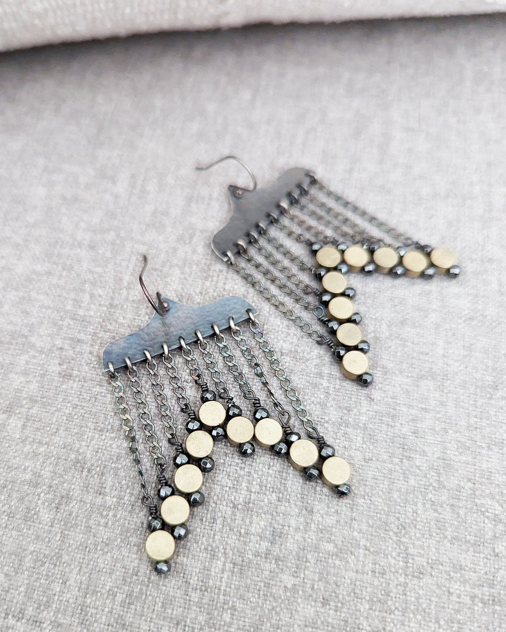 Bold black and gold statement earrings with hammered texture