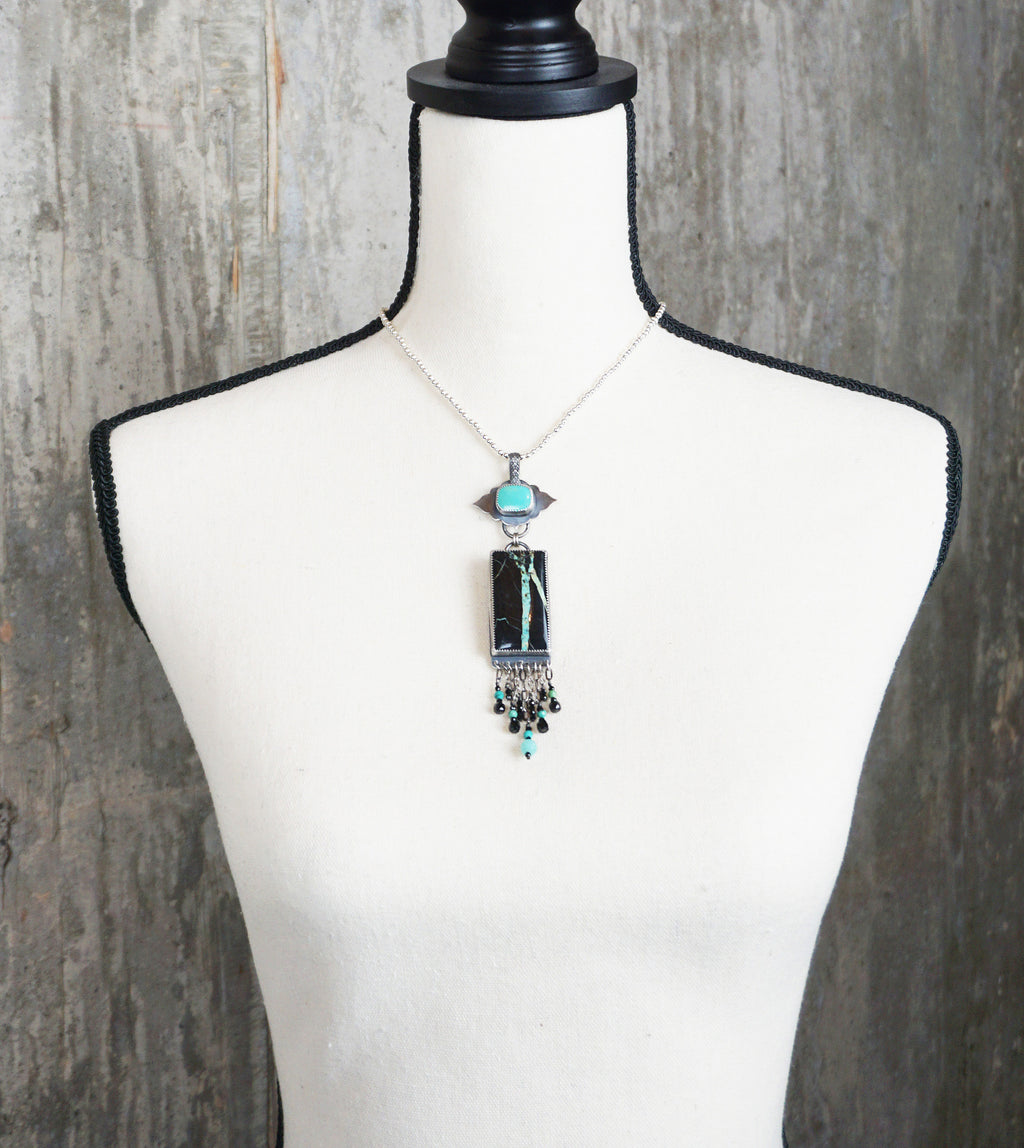 bold turquoise necklace with amazonite and black spinel beads on bust for scale