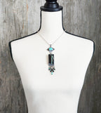 bold turquoise necklace with amazonite and black spinel beads on bust for scale