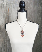 handcrafted silver pendant with vibrant gemstone fringe on bust for scale (chain not included)