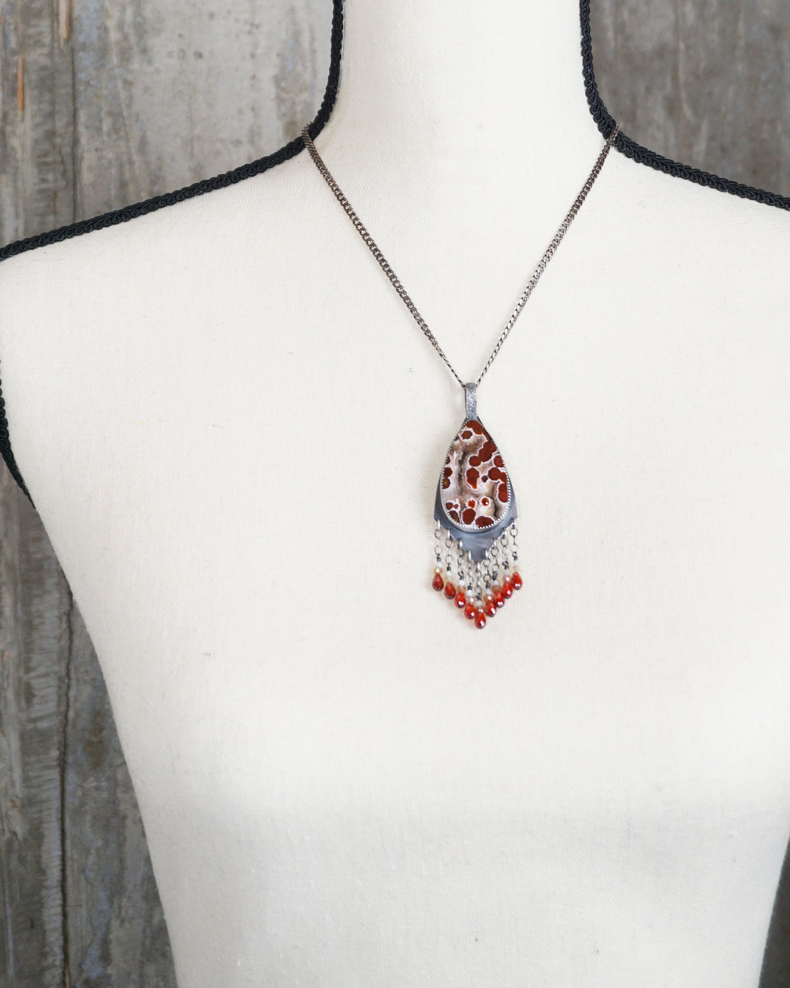 artisan gemstone pendant with mother of pearl and zircon beads on bust for scale (chain not included)
