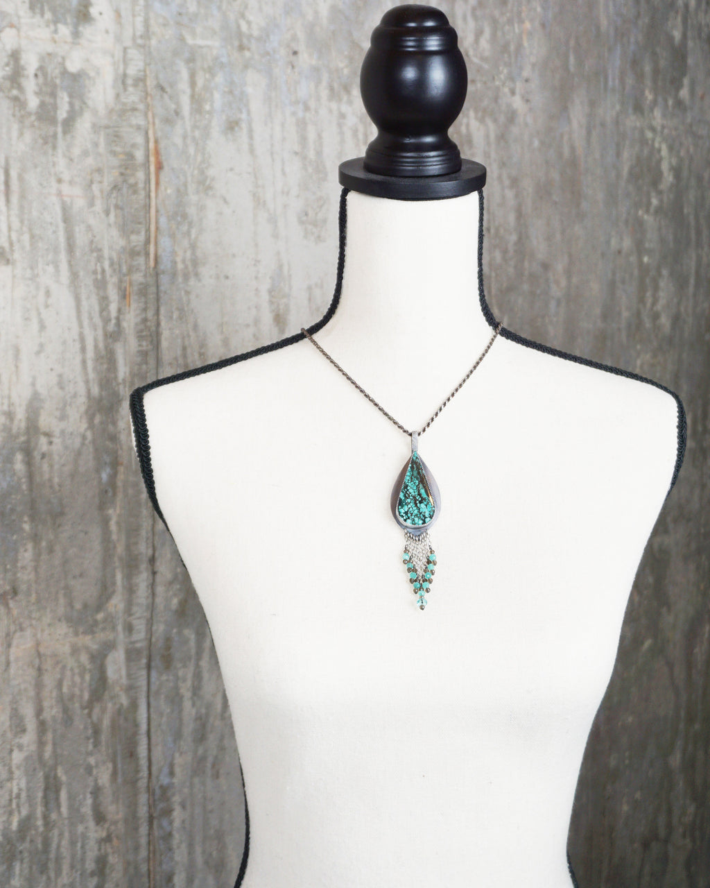 nature inspired pendant with turquoise magnesite and crystal accents on bust for scale (chain not included)
