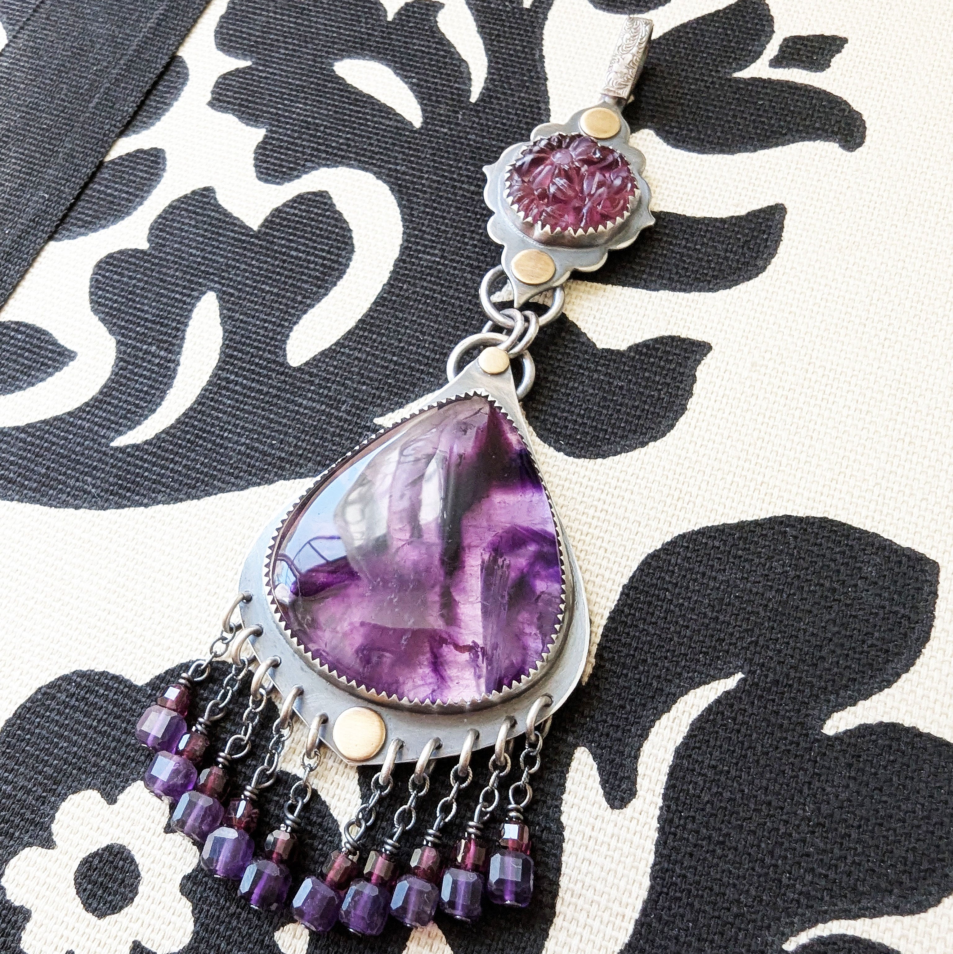 Vintage glass and trapiche amethyst pendant with garnet bead fringe by Rebellenhaus.