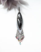 galaxy inspired pendant with dark tones and shimmering detail