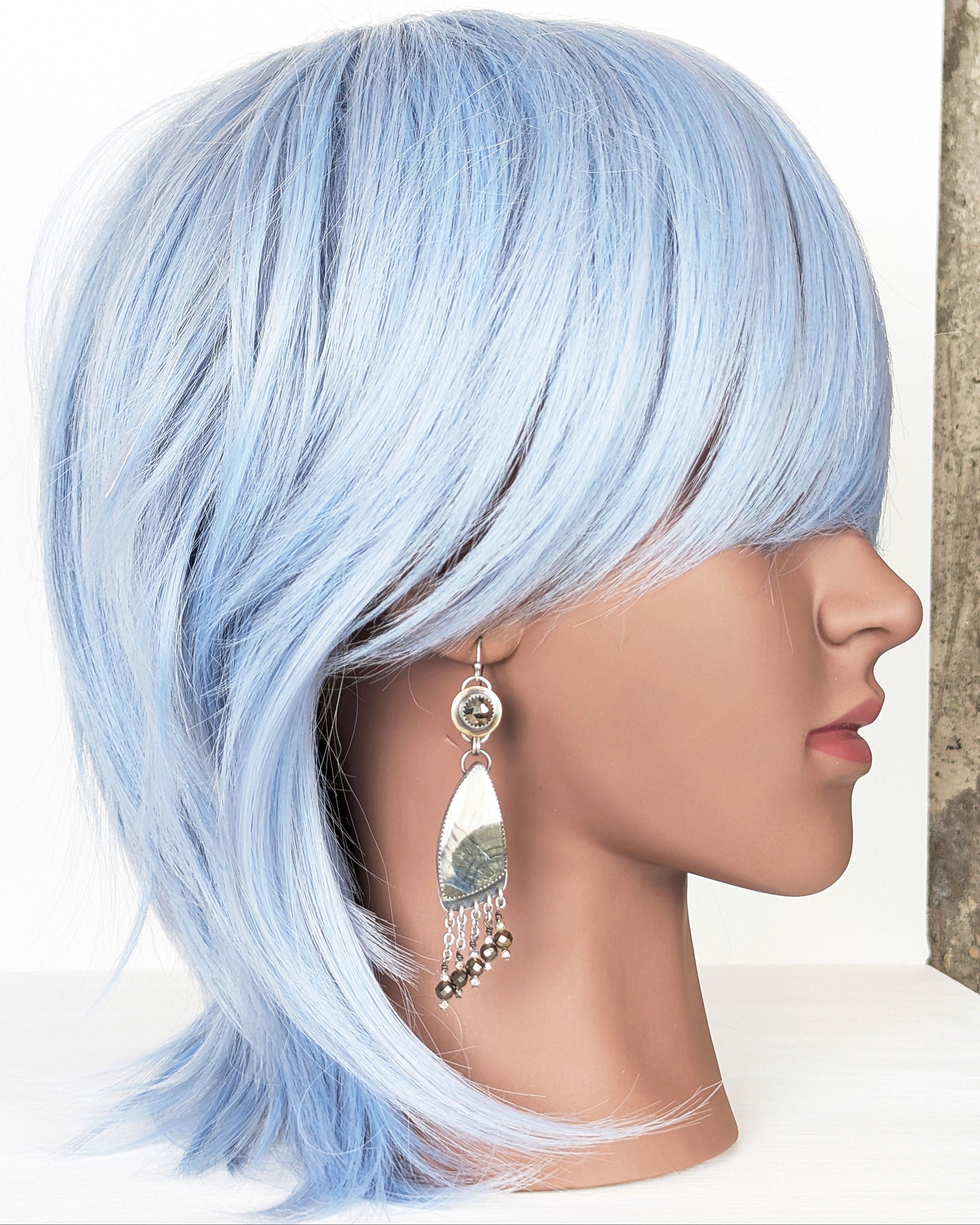 Oxidized sterling silver earrings with pyrite stones and fringe detail on mannequin for scale