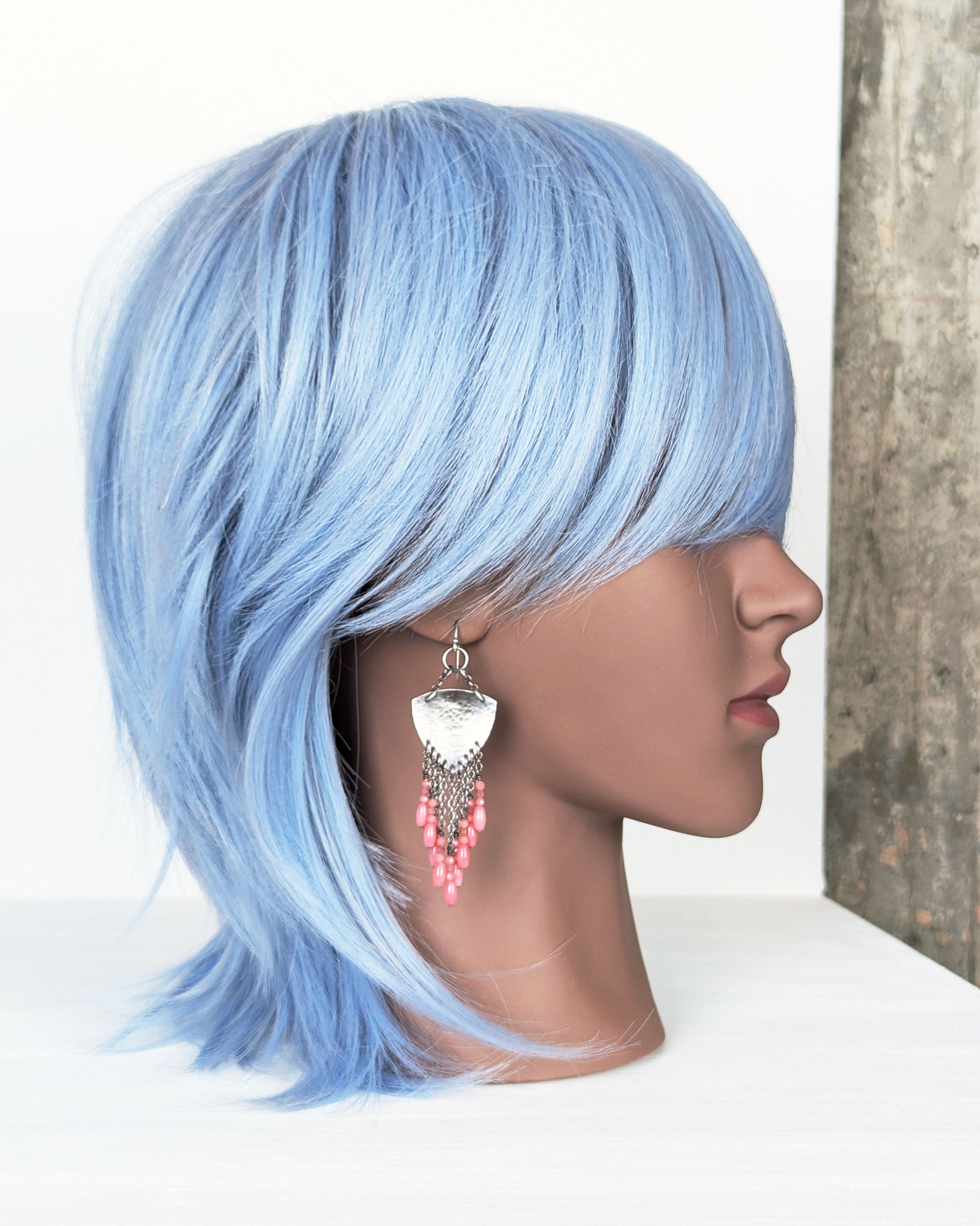 handcrafted oxidized silver earrings with pink bead details on mannequin for scale