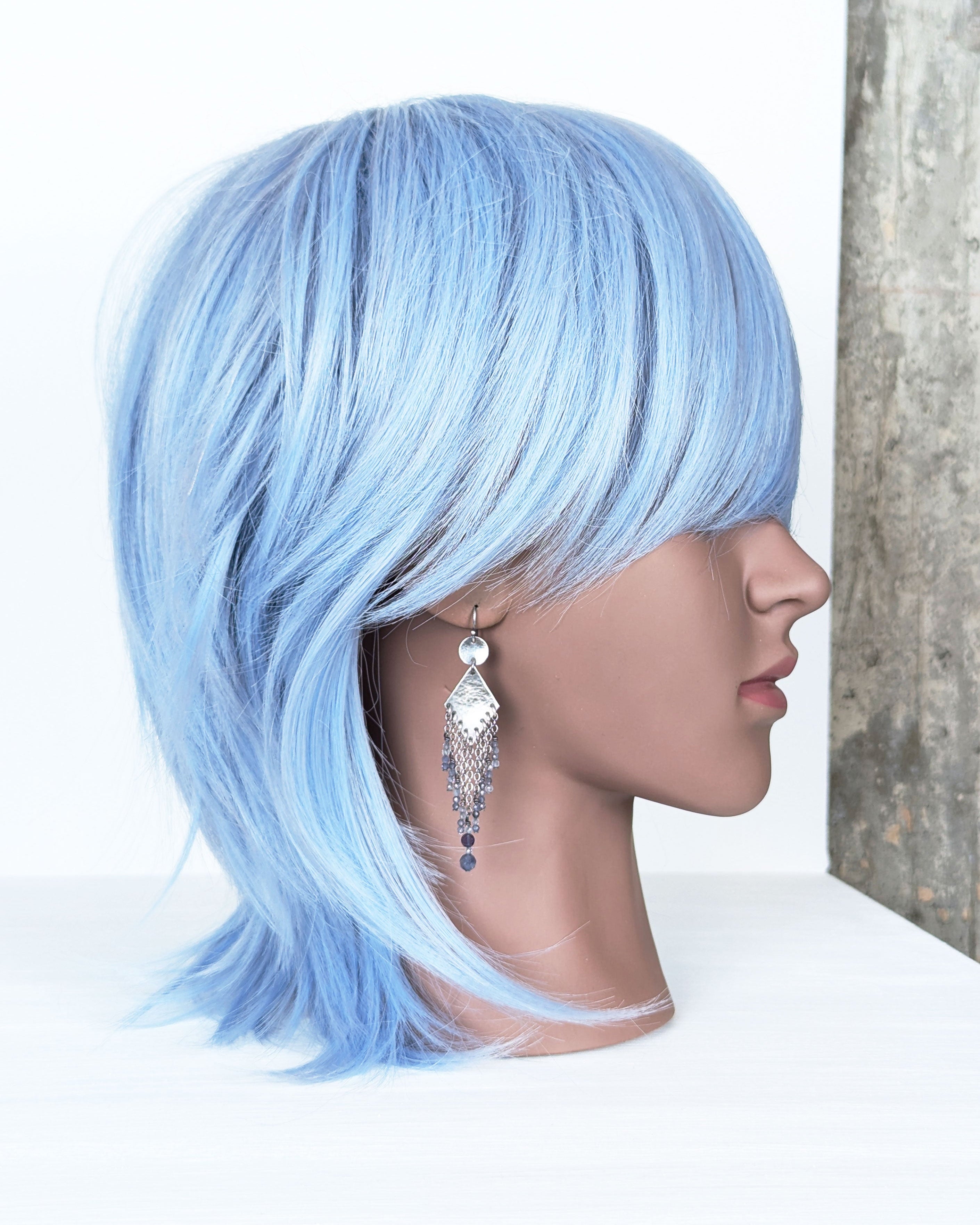long boho earrings with soft violet and deep blue gemstone fringe on mannequin for scale