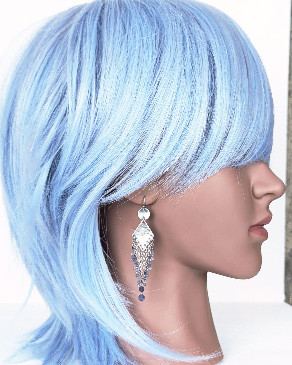 artisan silver drop earrings with diamond shape and beaded fringe on mannequin for scale