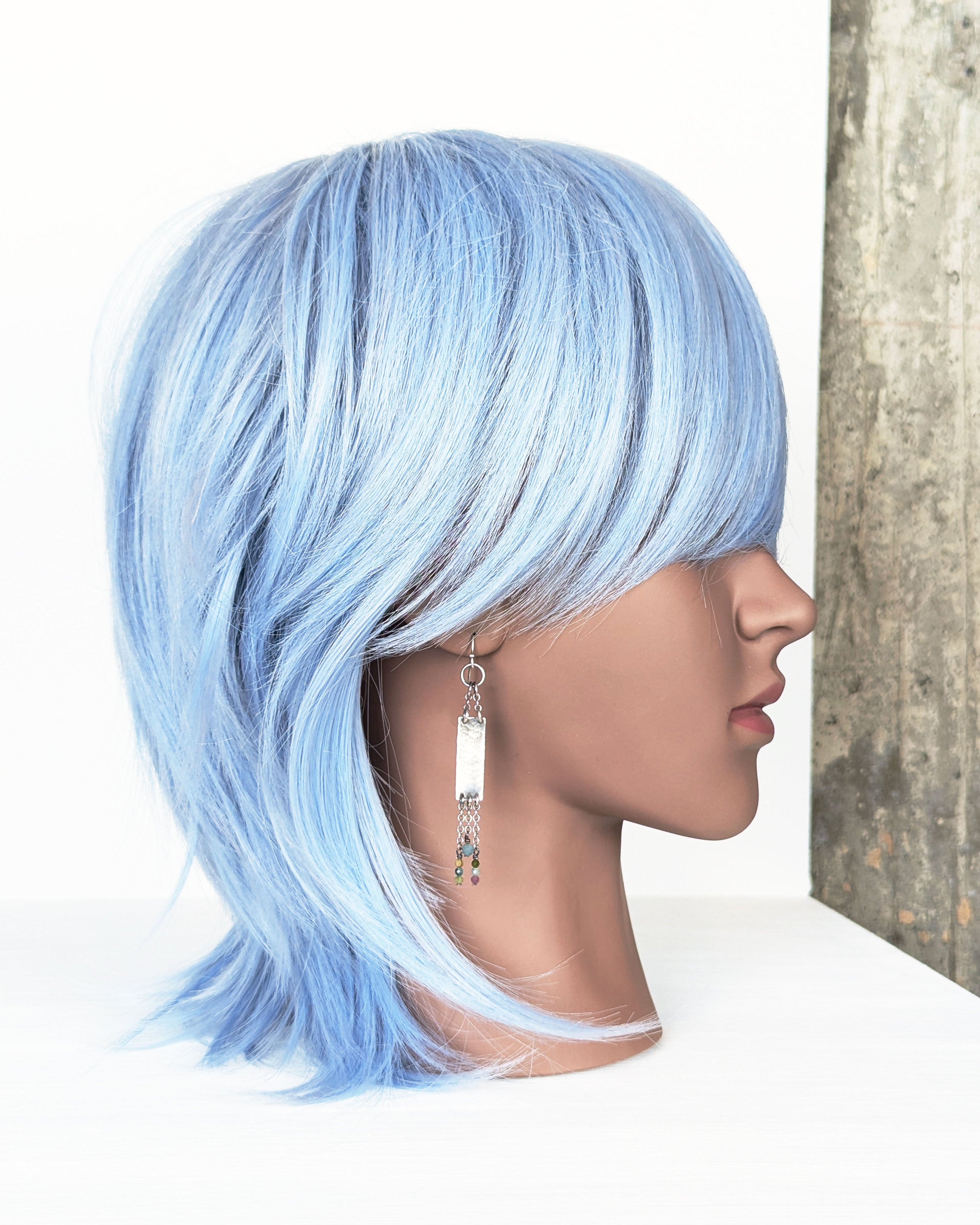 modern rustic silver earrings with long chain and gemstone detail on mannequin for scale