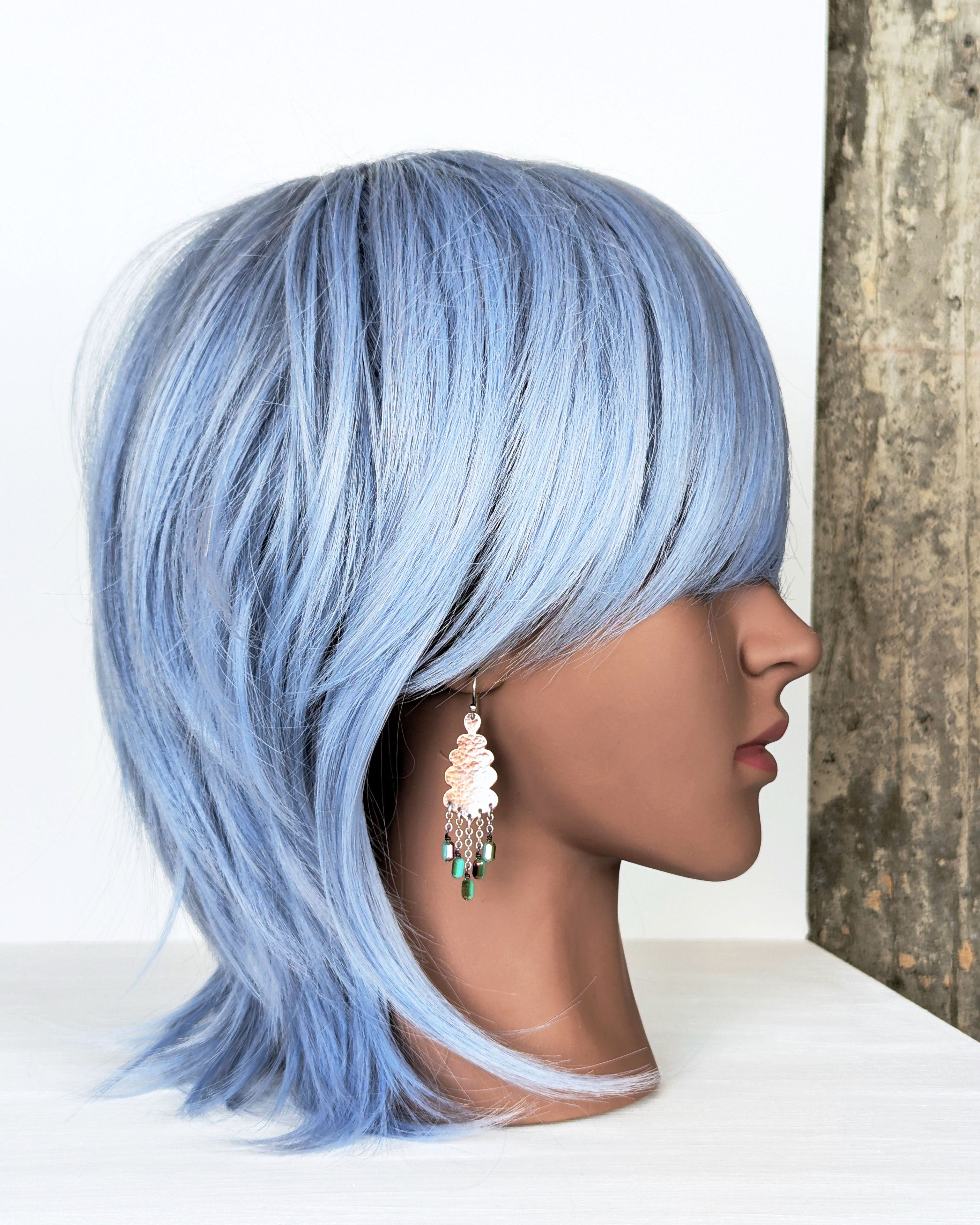 rustic artisan copper earrings with vibrant bead detail on mannequin for scale