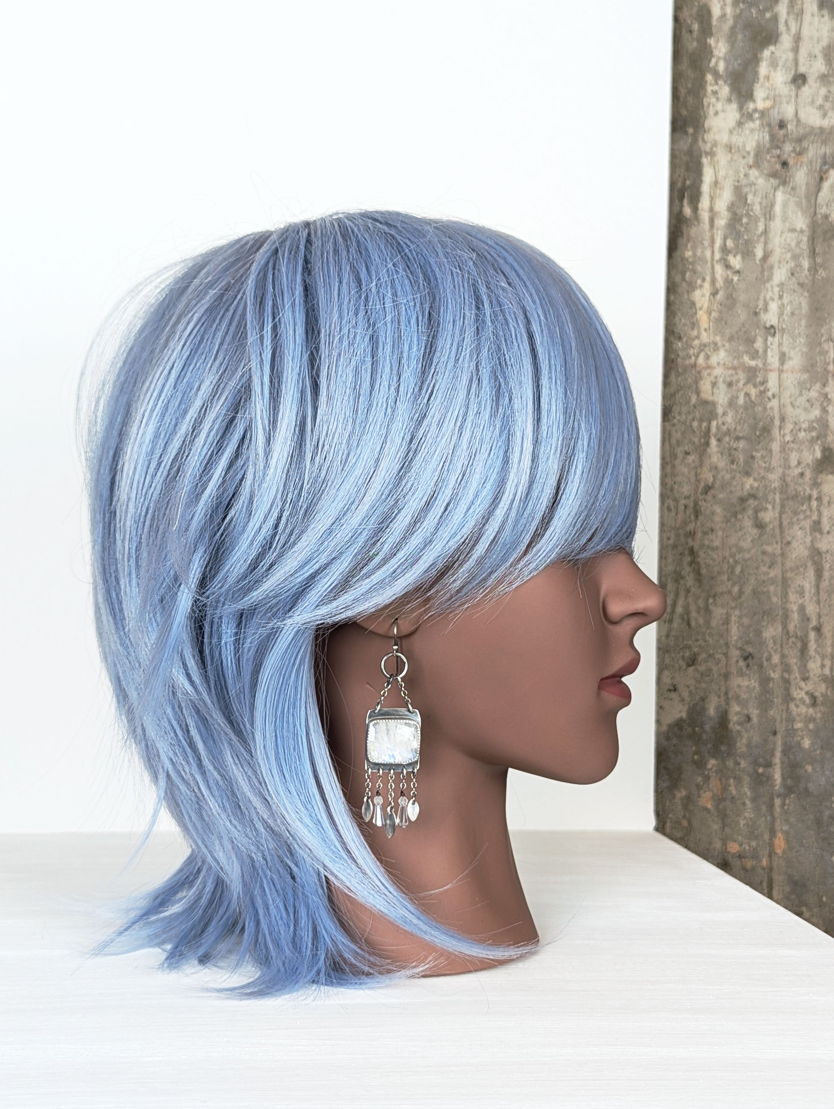 boho luxury earrings with moonstone and crystal accents on mannequin for scale