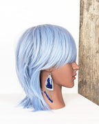 handcrafted oxidized silver earrings with large lapis stones on mannequin for scale