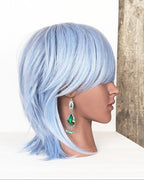 boho luxury earrings with vivid green tones and fringe on mannequin for scale