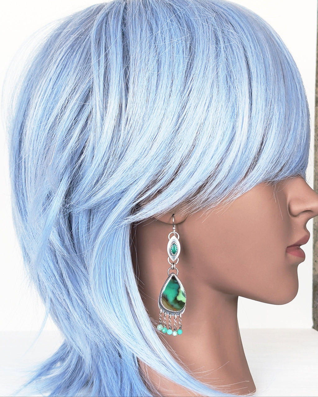 artisan silver earrings with layered green gemstone fringe on mannequin for scale