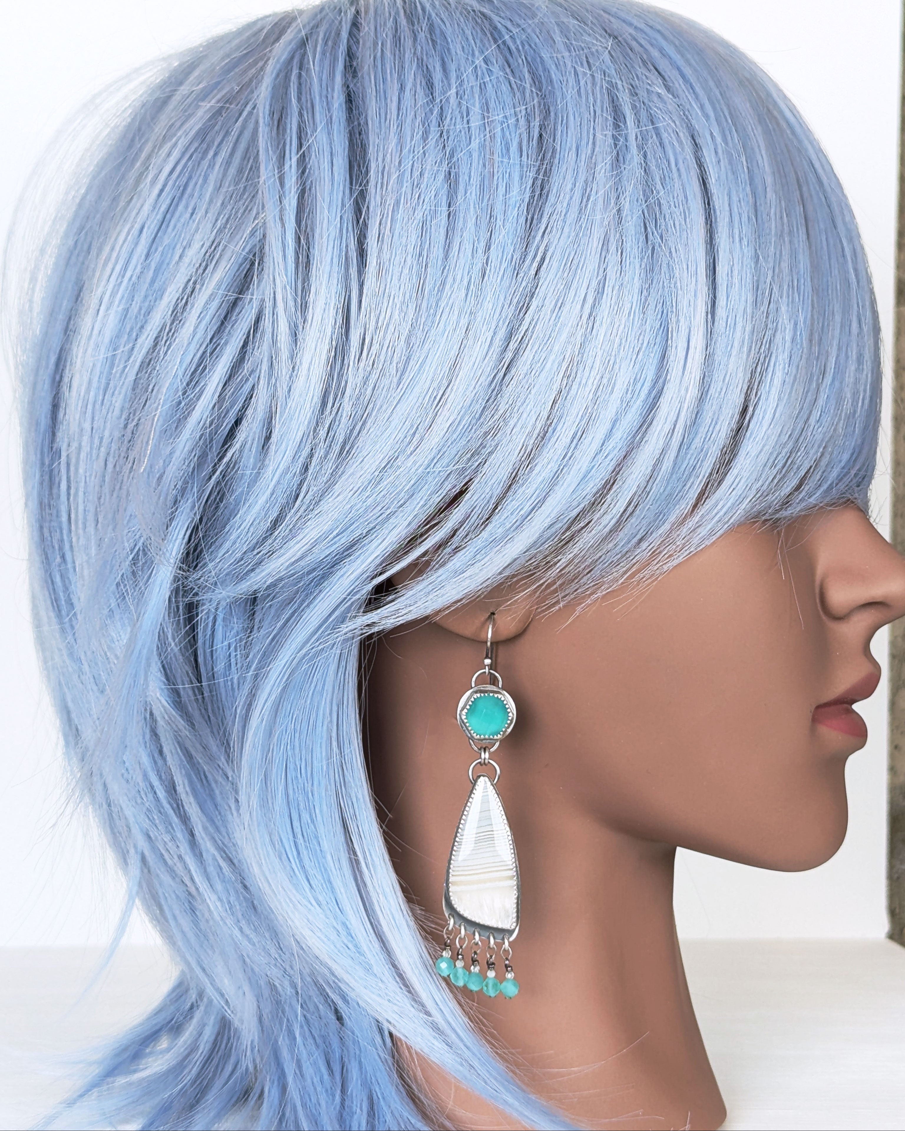 oxidized silver earrings with chalcedony and agate design on mannequin for scale