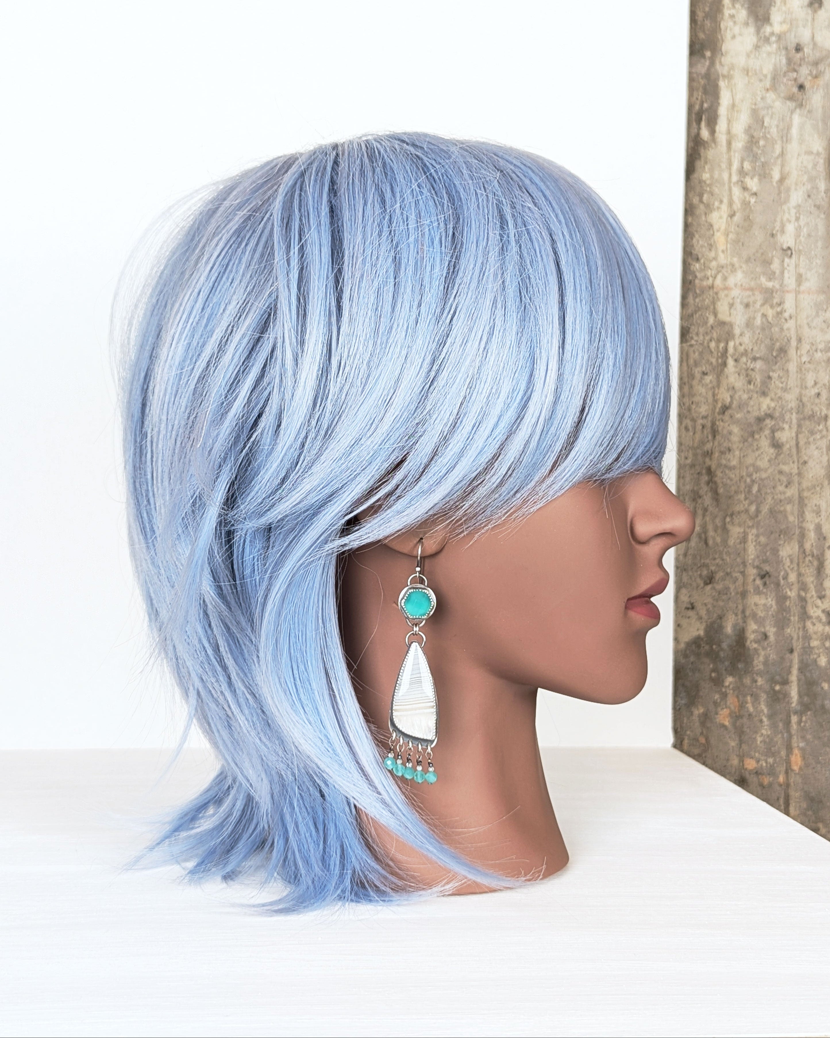 handcrafted silver earrings with turquoise chalcedony and fringe on mannequin for scale