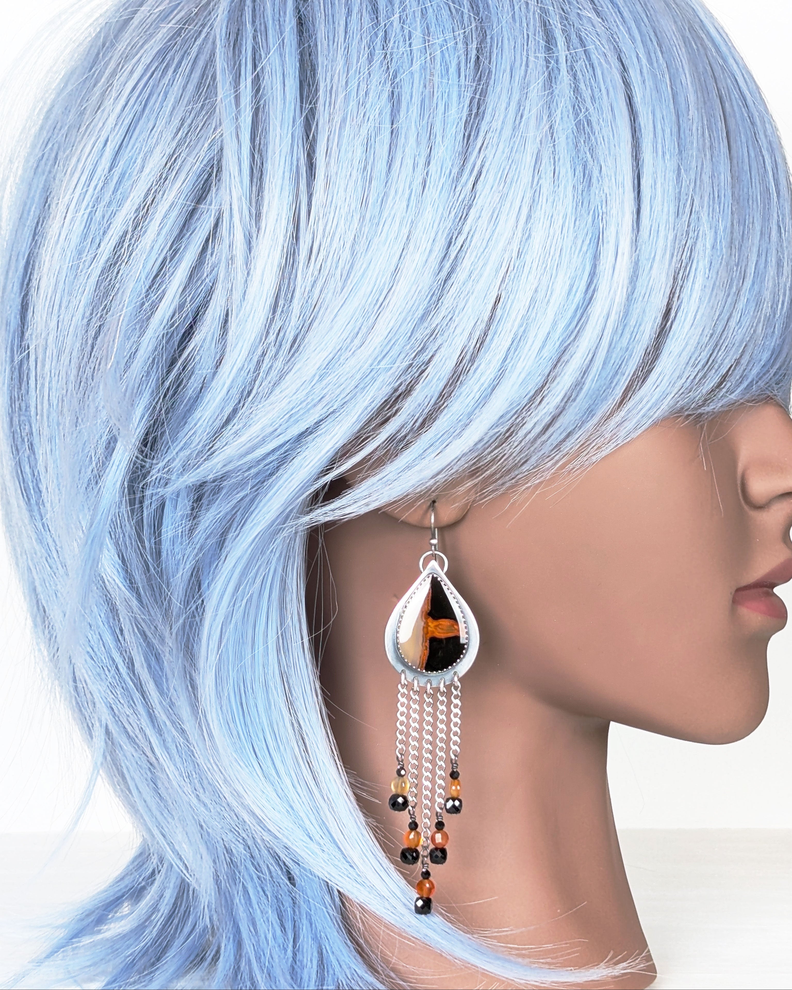 bold gemstone earrings with carnelian and black spinel beads on mannequin for scale