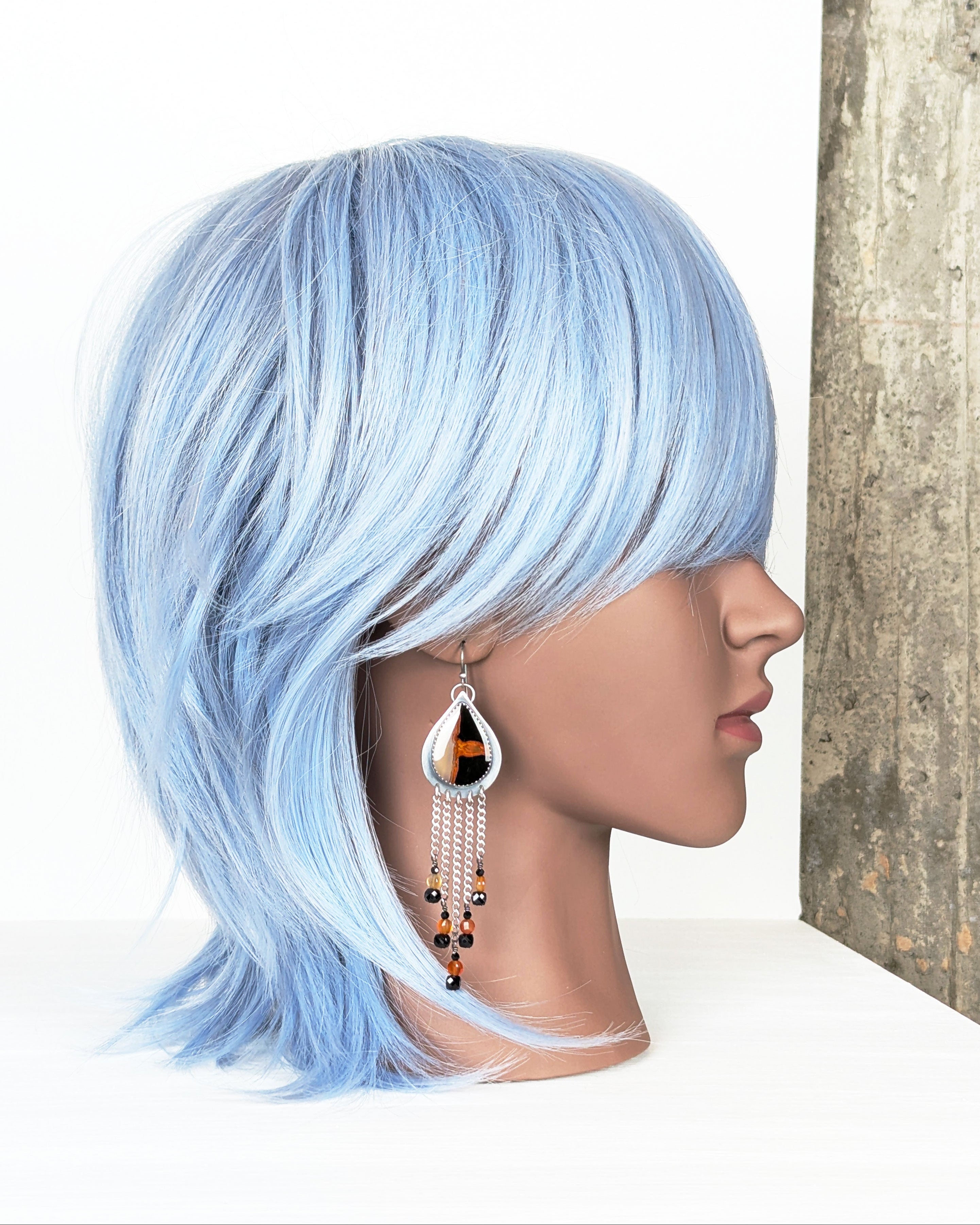 long fringe earrings with orange and black agate stones on mannequin for scale