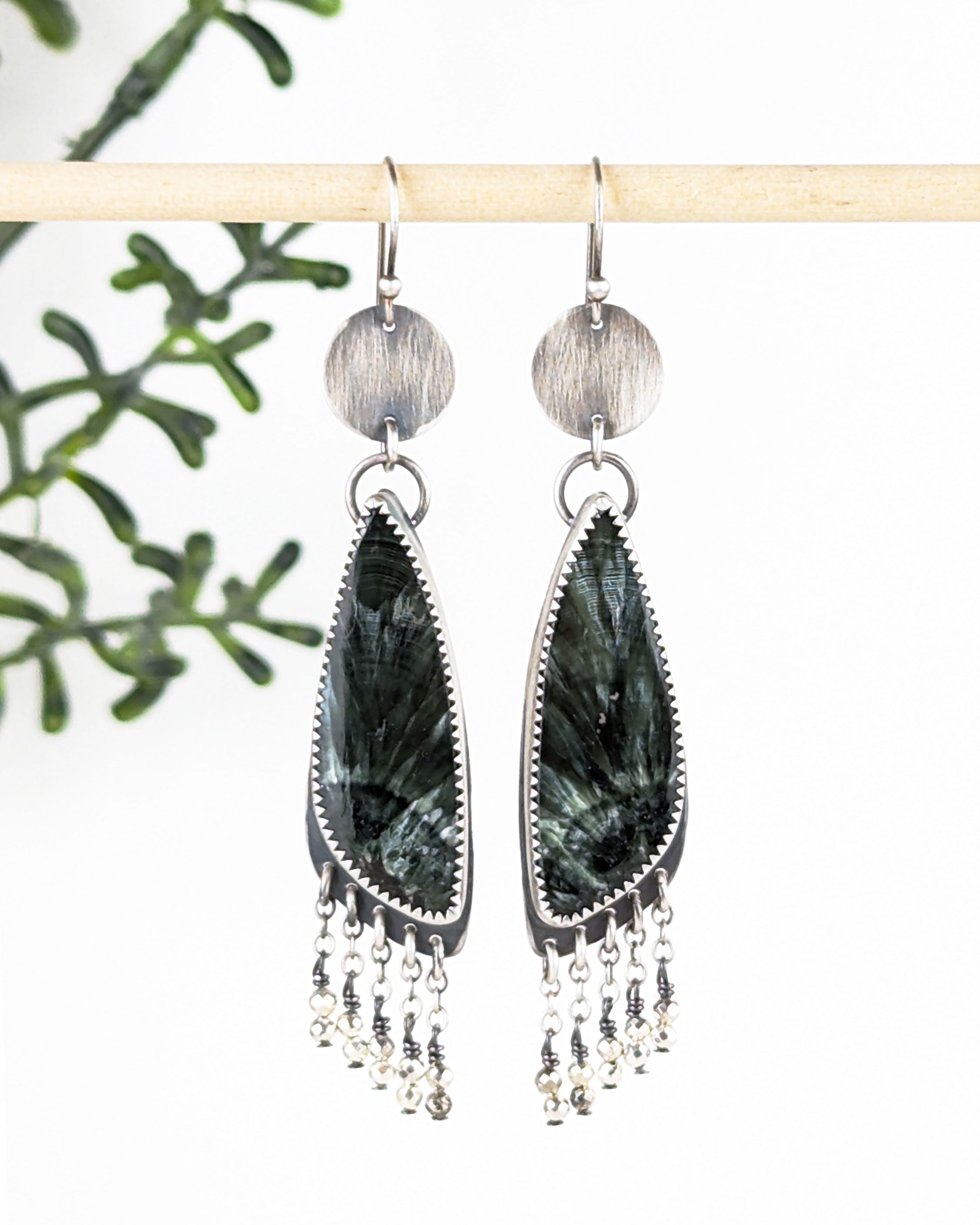 green gemstone earrings with asymmetrical triangular stone design