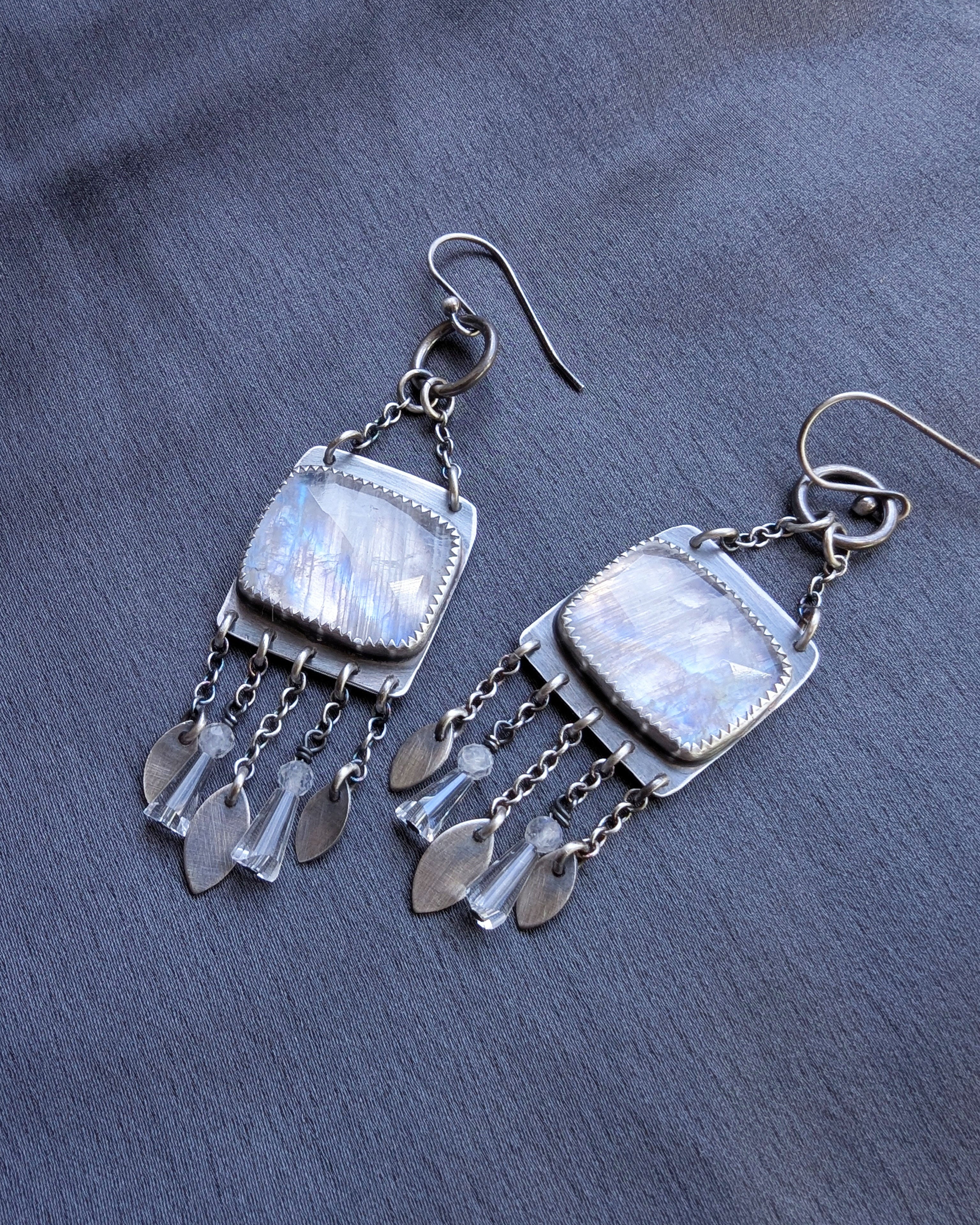 luminous gemstone earrings with soft blue flash and silver fringe