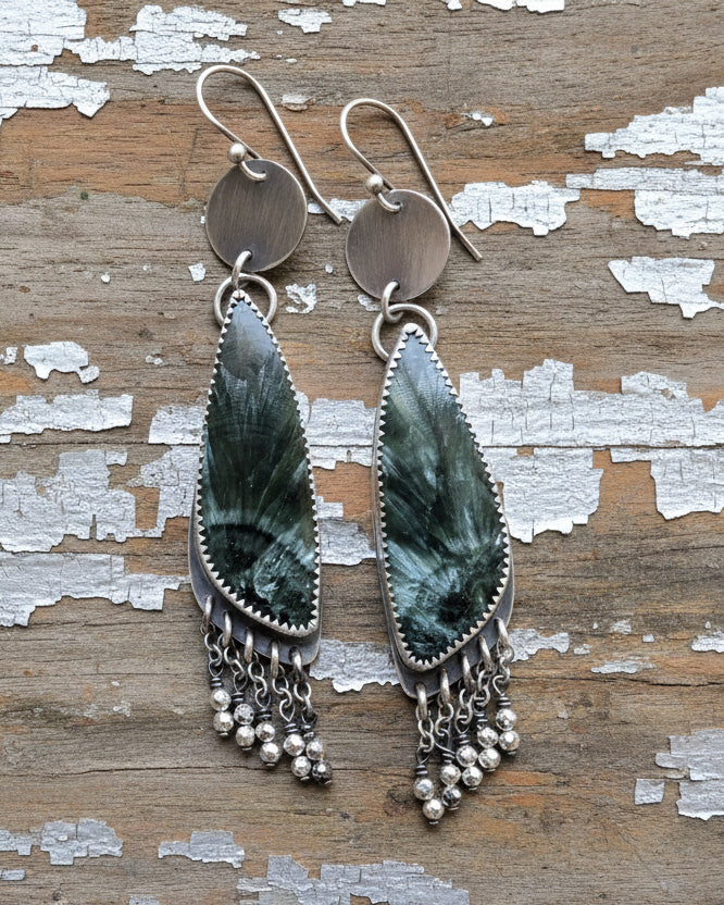 long fringe earrings with seraphinite and metallic pyrite beads on mannequin for scale