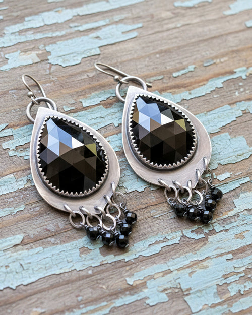 elegant black earrings with flowing beaded fringe and silver design