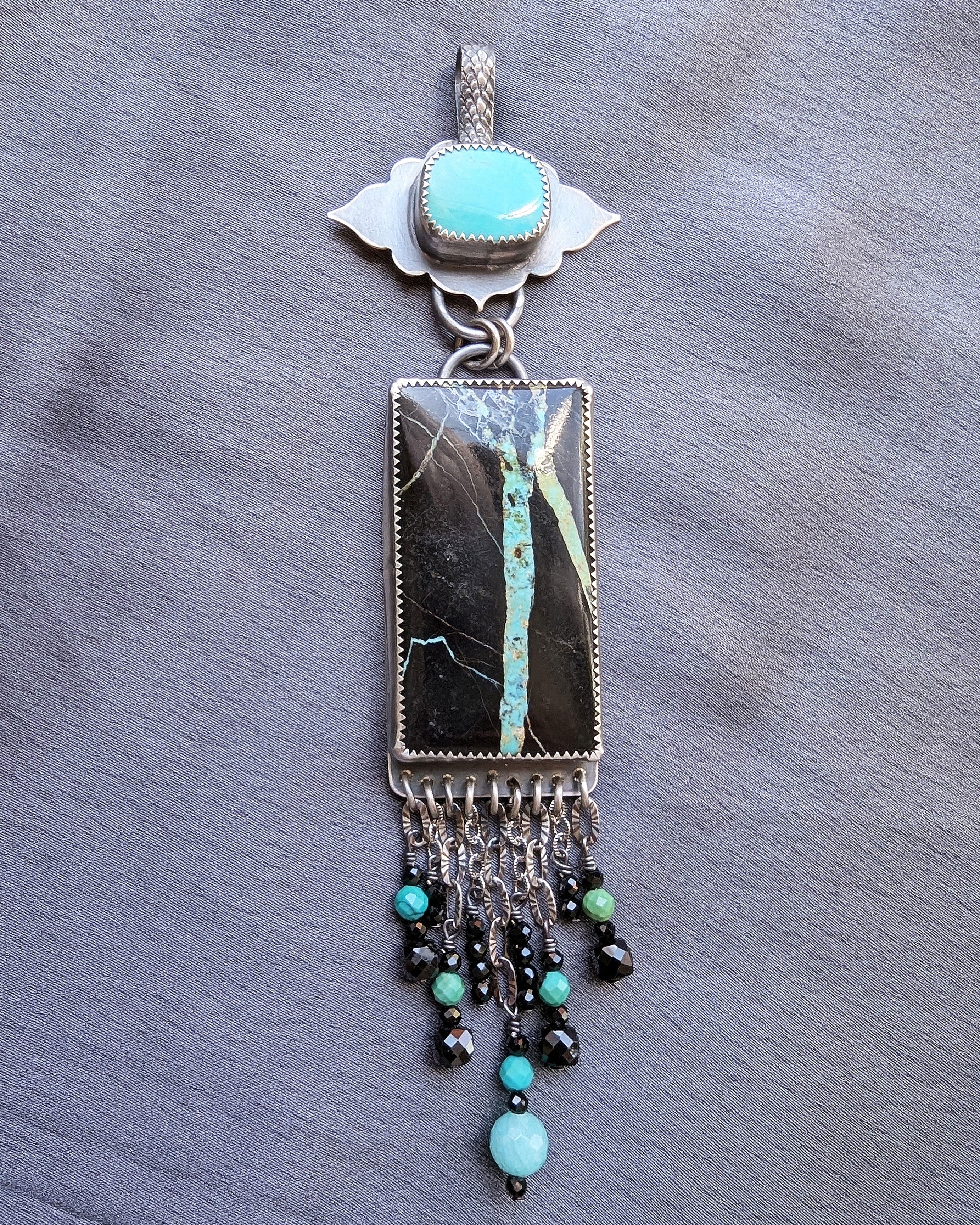 handcrafted silver pendant with turquoise and gemstone accents